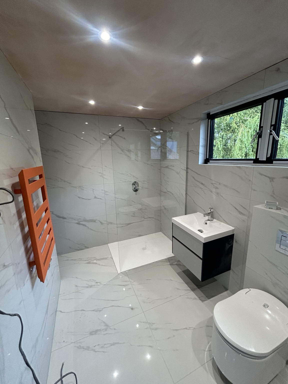 Marble-effect shower bathroom by JMB Plumbing & Heating