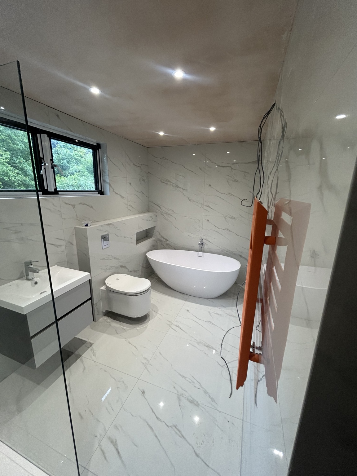 Marble-effect bathroom with freestanding bath, second view