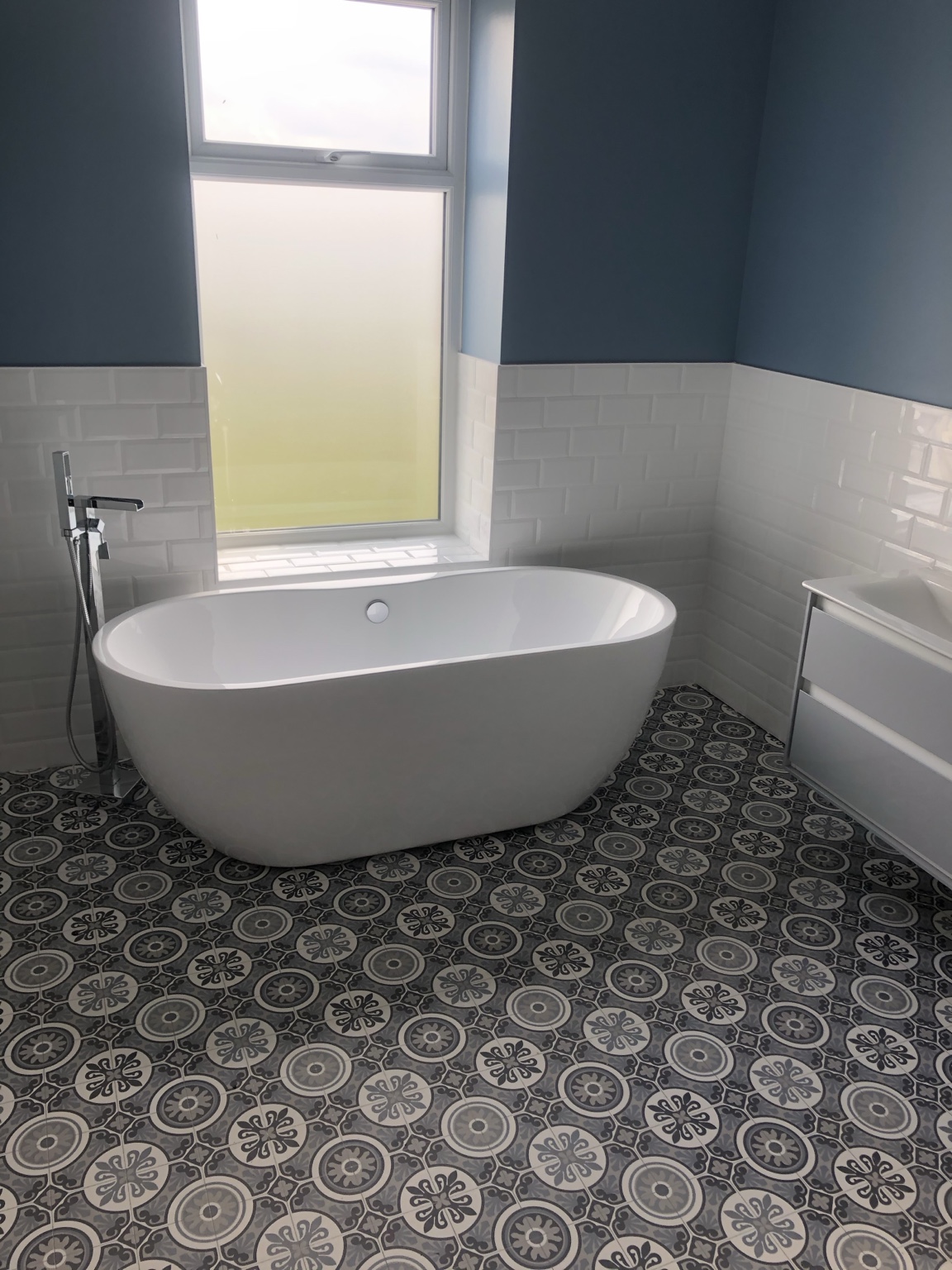 Blue and white bathroom with freestanding bath, second view